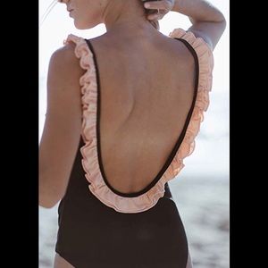 Black one piece bathing suit with pink ruffle